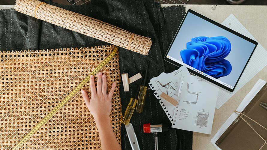 A Woman Measuring A Sample Fabric Material